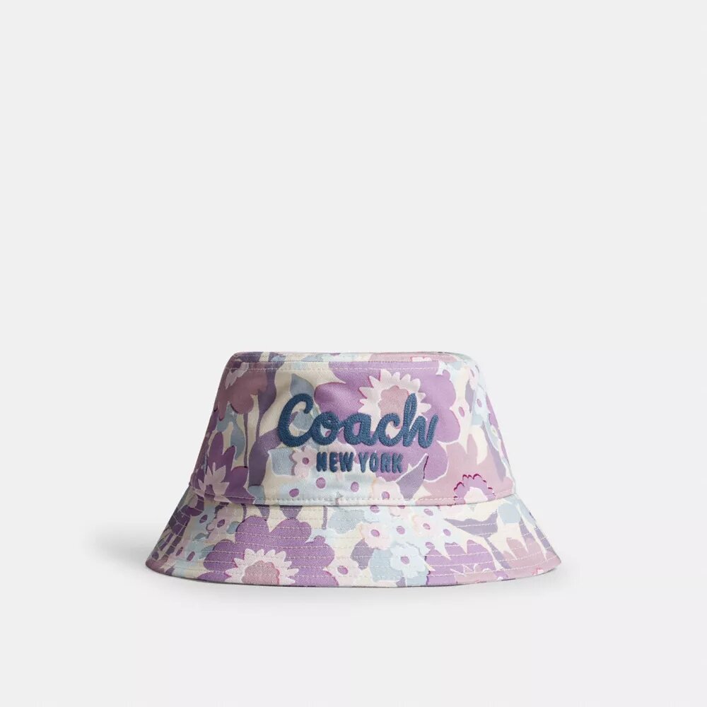 Buckethat med Coach-skrift og blomsterprint