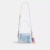 Carey crossbody-taske i Loved Denim med vedhæng