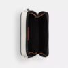 Charter Slim crossbody-taske i Signature Canvas