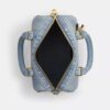 Mini Rowan crossbody-taske i slidt denim med vedhæng